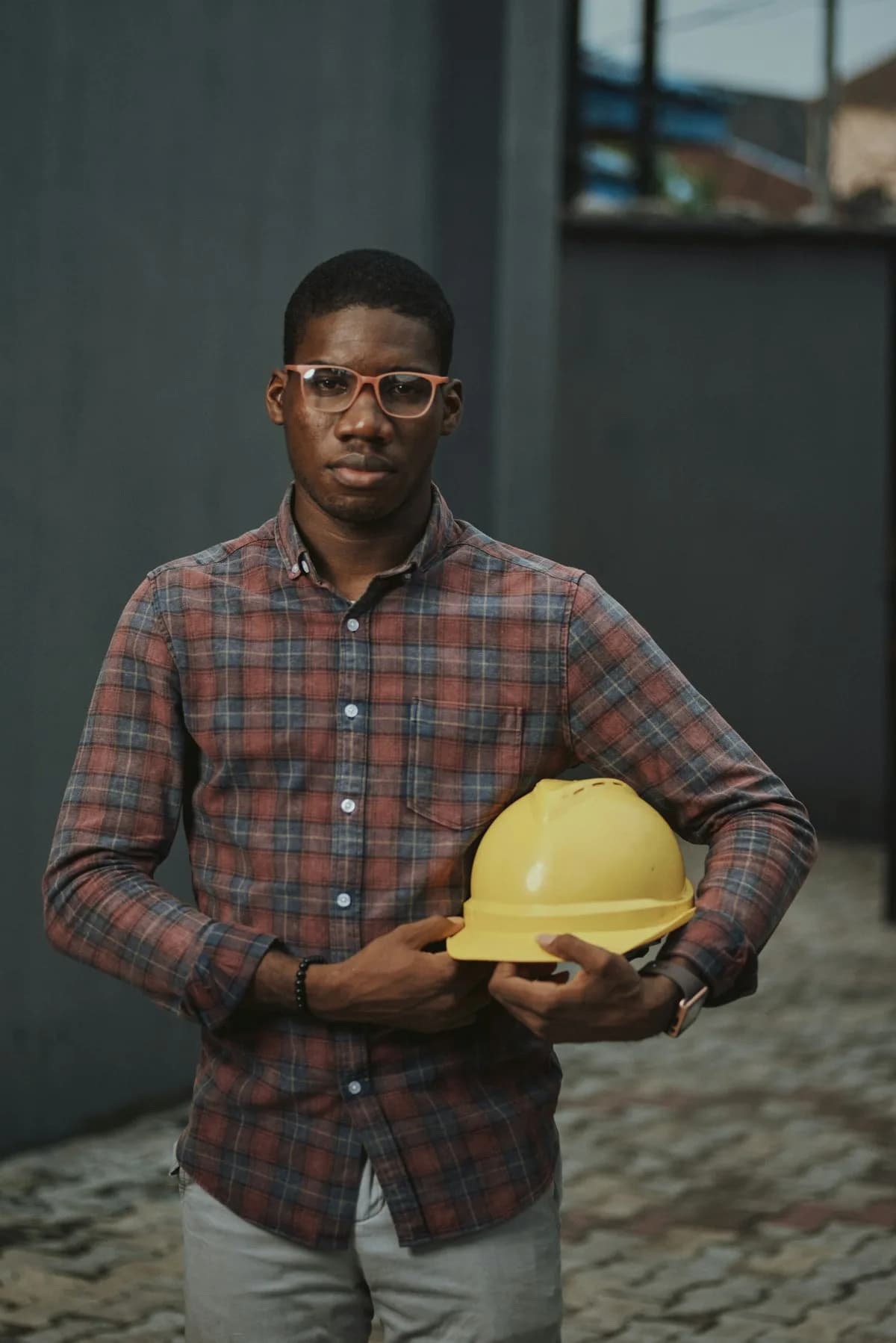 Sam Calloway holding his hard hat on a job site